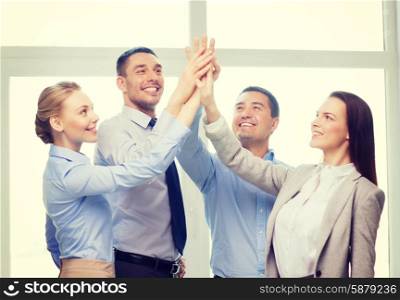 success, business, office and winning concept - happy business team giving high five in office