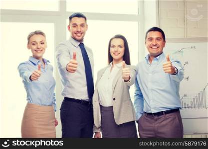 success, business, office and winning concept - happy business team showing thumbs up in office
