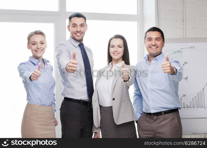 success, business, office and winning concept - happy business team showing thumbs up in office