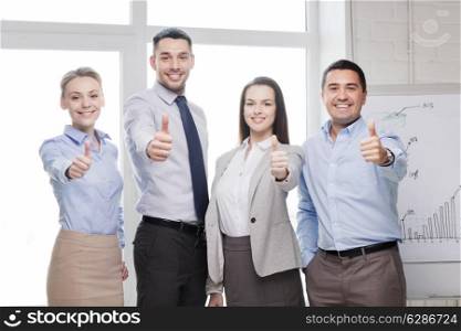 success, business, office and winning concept - happy business team showing thumbs up in office