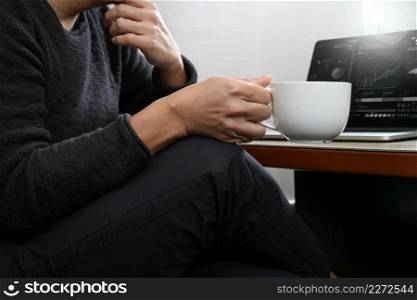 success businessman hand using smart phone,digital tablet docking smart keyboard,coffee cup on wooden desk