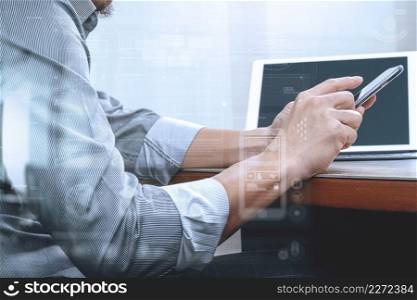 success businessman hand using smart phone,digital tablet docking smart keyboard on wood desk