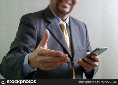success businessman open his hand,smart phone,front view,filter effect