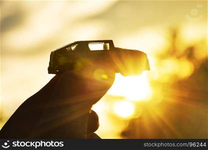 Success concept, Holding toy car in the sky at sunset. Dream car