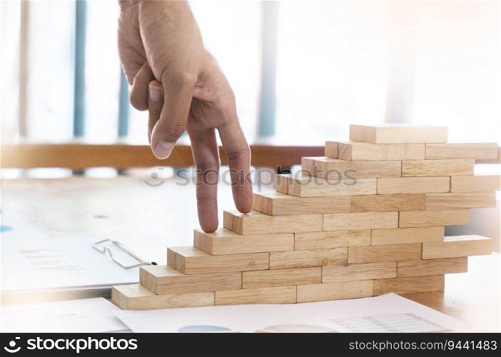Success concept with business woman hand climbing wooden block stairs Business Concept