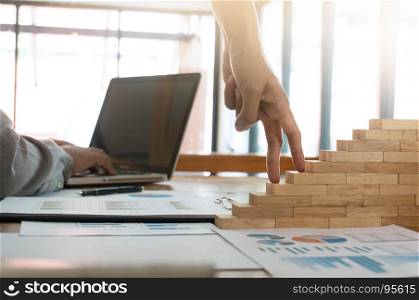 Success concept with business woman hand climbing wooden block stairs in Business Concept.