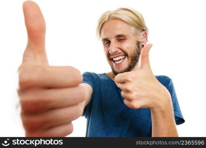 Success concept. Young college student giving thumb up hand sign gesture, isolated on white. Content young man giving thumb up