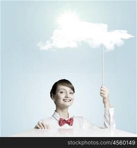 Success concept. Young woman holding balloon with sun shining above