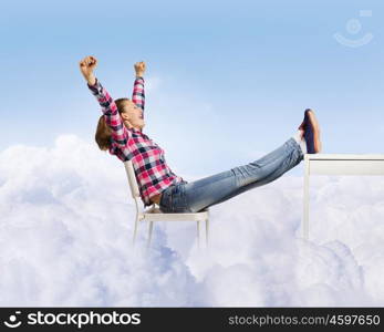 Success concept. Young woman in casual with arms up celebrating success