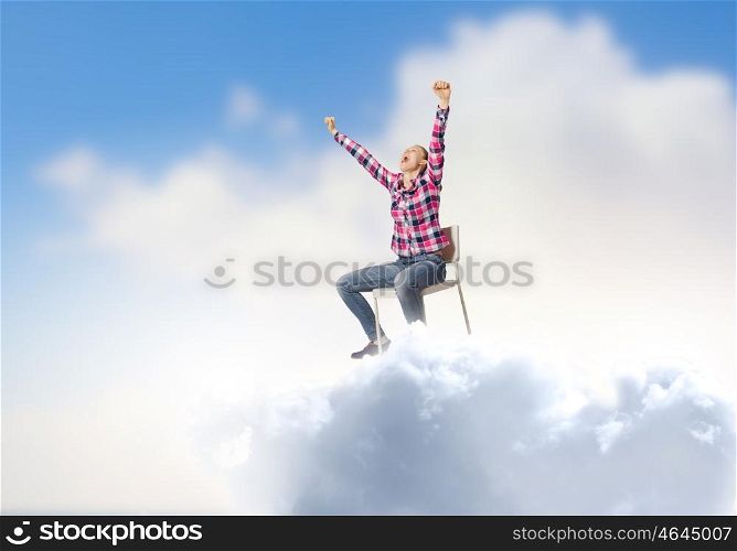 Success concept. Young woman in casual with arms up celebrating success