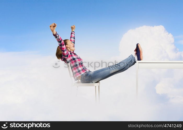 Success concept. Young woman in casual with arms up celebrating success