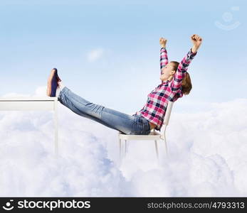 Success concept. Young woman in casual with arms up celebrating success