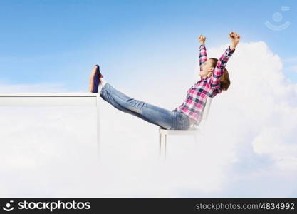 Success concept. Young woman in casual with arms up celebrating success