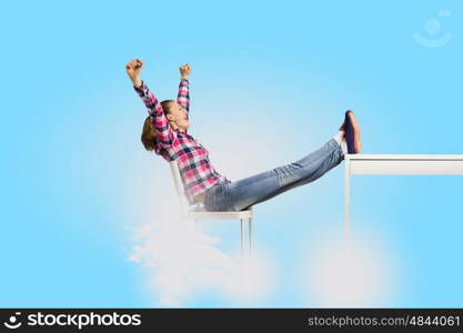 Success concept. Young woman in casual with arms up celebrating success