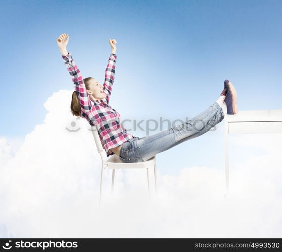 Success concept. Young woman in casual with arms up celebrating success