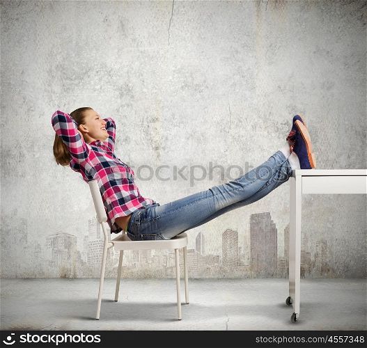 Success concept. Young woman in casual with legs on table