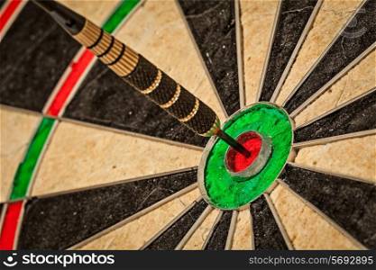 Success hitting target aim goal achievement concept background - dart in bull&#39;s eye close up