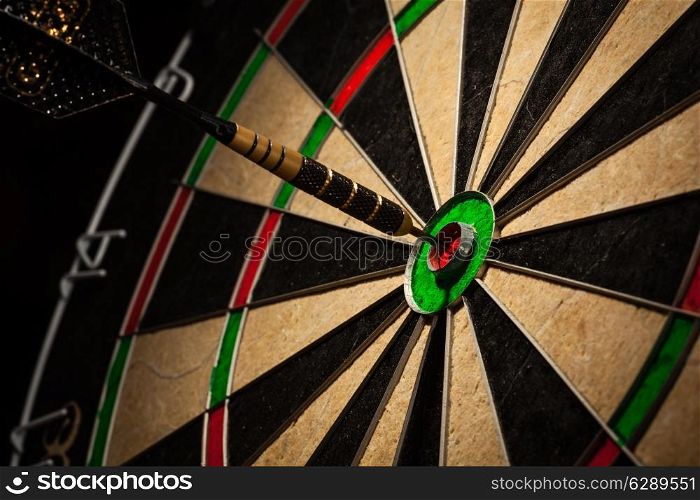 Success hitting target aim goal achievement concept background - dart in bull&rsquo;s eye close up