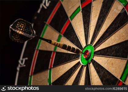Success hitting target aim goal achievement concept background - dart in bull&rsquo;s eye close up