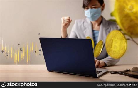 Success in Blockchain Economic Investment during Coronavirus Crisis Concept. Cheerful Young Woman Wearing Medical Mask while Using Computer Laptop to Buy and Sell Bitcoin via Cryptocurrency Exchange.