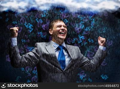 Success in business. Cheerful businessman with hands up celebrating success