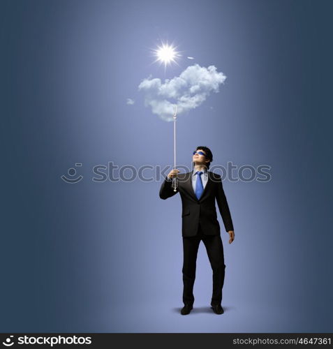 Success in business. Image of businessman in goggles looking at sun