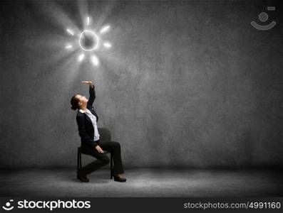 Success in business. Image of businesswoman sitting on chair under sun lights