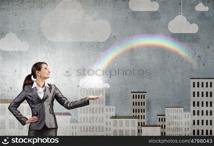 Success in business. Young businesswoman and colorful rainbow in hand