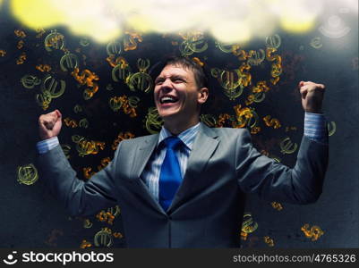 Success in business. Young joyful businessman with hands up celebrating success