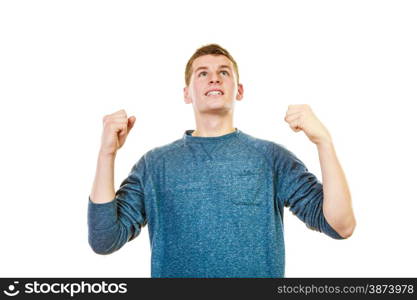 Success positive emotions. Happy young man successful lad with arms up looking upwards clenching fist isolated on white background