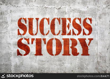 success story sign painted in stencil font on an old, grunge stucco texture wall