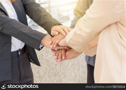 Success Teamwork Concept, Business people joining hands city background.