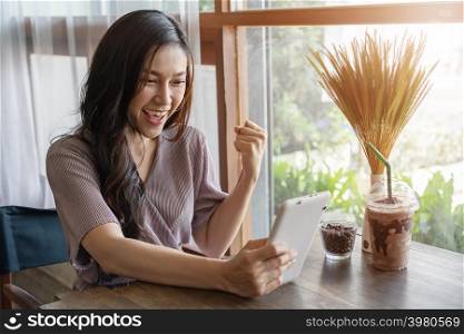 success woman using tablet in the cafe