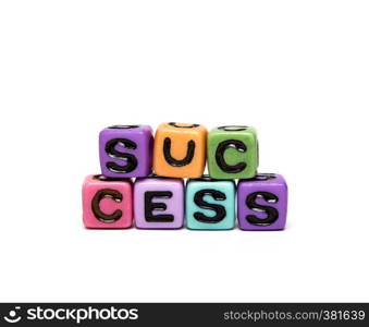 success - word made from multicolored child toy cubes with letters