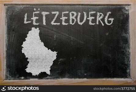 Successful, beautiful and confident young woman showing map of luxembourg on blackboard for presentation, marketing research and tourist advertising