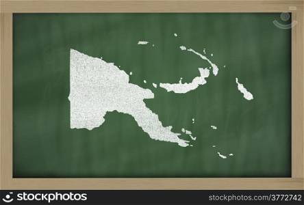 Successful, beautiful and confident young woman showing map of papua new guinea on blackboard for presentation, marketing research and tourist advertising