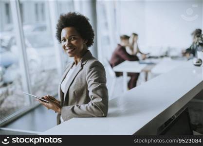 Successful black Afro American business woman working with digital tablet at the modern office