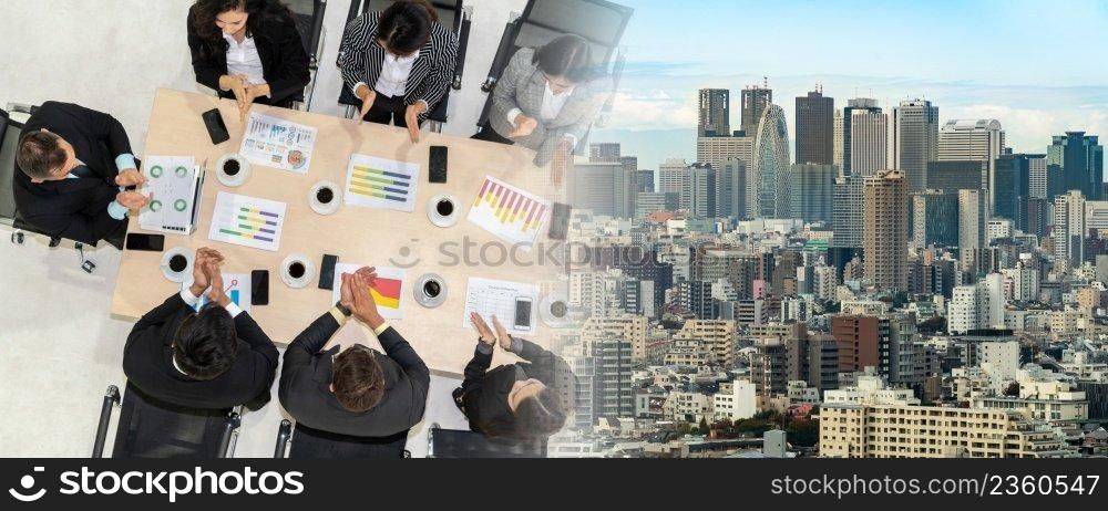 Successful business people celebrate together with joy at office table shot from top view . Young businessman and businesswoman workers express cheerful victory showing teamwork in broaden view .. Successful business people celebrate together with joy broaden view