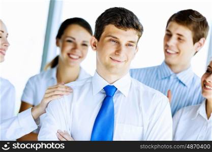 Successful business people. Image of young businesspeople congratulating colleague. Success concept