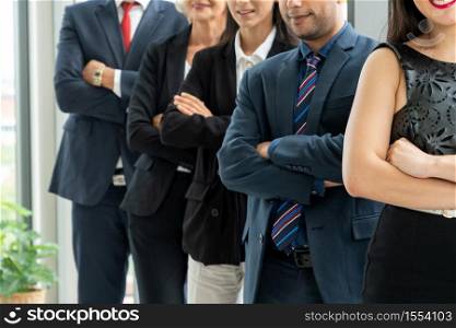 Successful business people standing together showing strong relationship of worker community. A team of businessman and businesswoman expressing a strong group teamwork at the modern office.