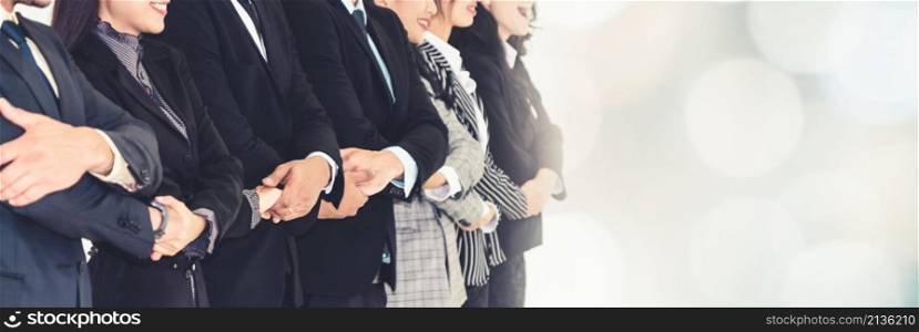 Successful business people standing together showing strong relationship of worker community. A team of businessman and businesswoman expressing a strong group teamwork at office broaden view. Successful business people standing together broaden view