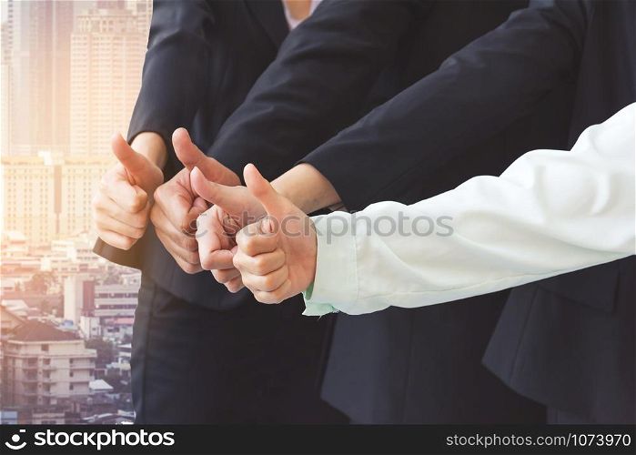Successful business people with thumbs up, business team