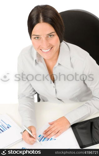 Successful business woman at office smiling working on charts