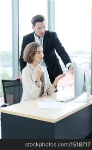 Successful businessman and businesswoman working and share ideas at office computor desk