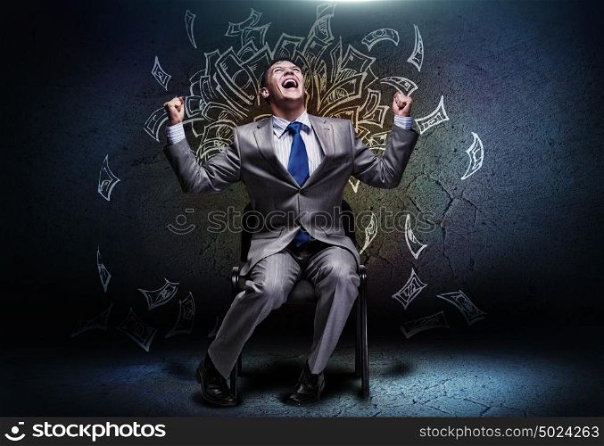 Successful businessman. Cheerful businessman sitting on chair and screaming ahead