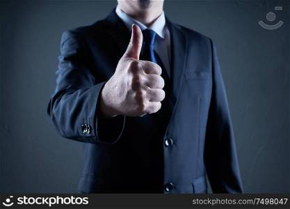 Successful businessman gives thumb up pose. Likes and positive feel. Gesture good and agree , finger agreement