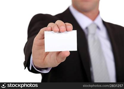 successful businessman holding business card