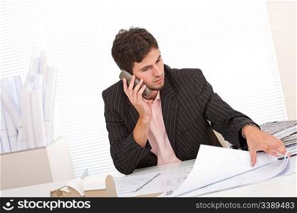 Successful businessman on the phone at office