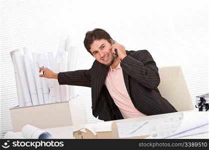 Successful businessman on the phone at office