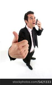 successful businessman on the phone with close up on thumb up